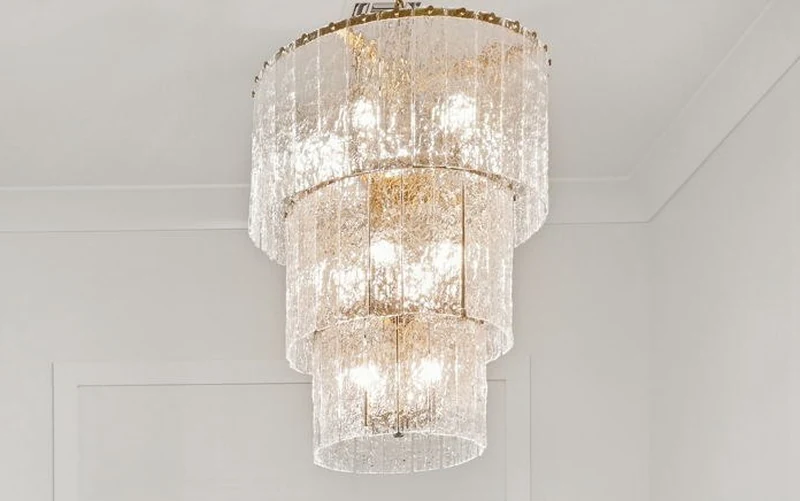 Tiered glass and brass chandelier, entry